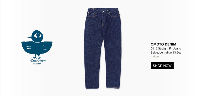 A pair of indigo blue straight fit jeans is displayed in the center. To the left is a blue bird logo with Omoto Denim text. On the right, product details and a black Shop Now button appear on a white background. 