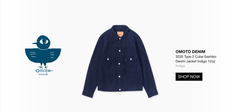 A dark blue denim jacket with buttoned chest pockets is displayed alongside a blue bird logo and the text “OMOTO DENIM 3220 Type 2 Cube Sashiko Denim Jacket Indigo 12oz.” A “SHOP NOW” button appears below the description. 