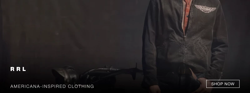 A person wearing a black jacket with a winged logo stands against a dark background next to a vintage motorcycle frame. Text reads “RRL” and “AMERICANA-INSPIRED CLOTHING.” A button says “SHOP NOW.”. 